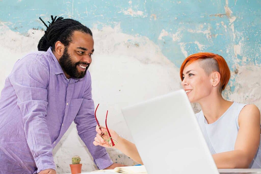 Two diverse professionals collaborating at Togetmedia office.